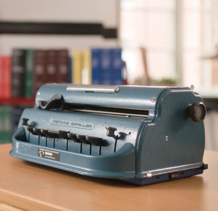 Perkins Braille Bloom clipped onto Perkins Brailler